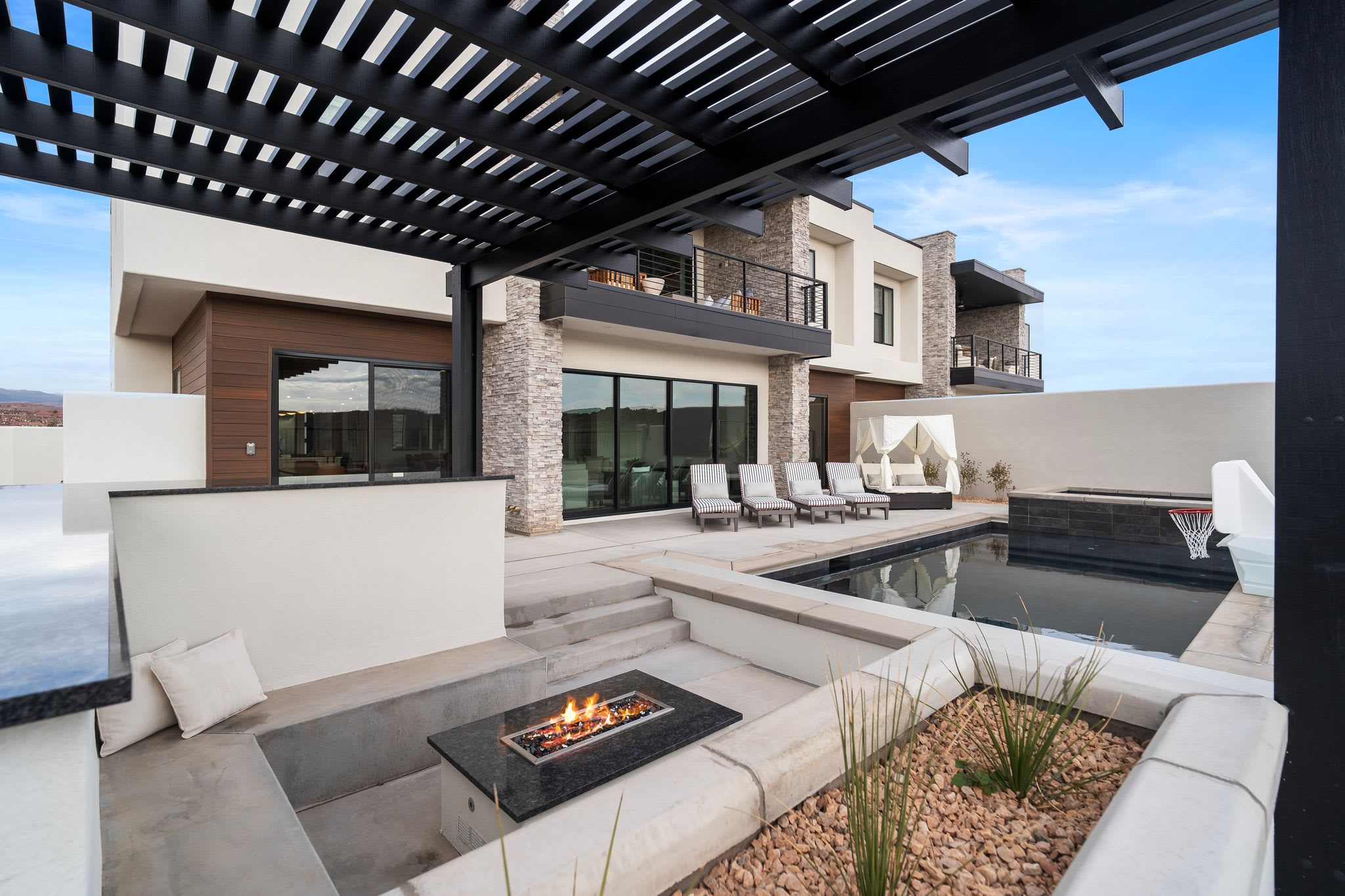 Pool, fire pit, and outdoor gathering area at Coastal Isle Luxury Retreat in Southern Utah